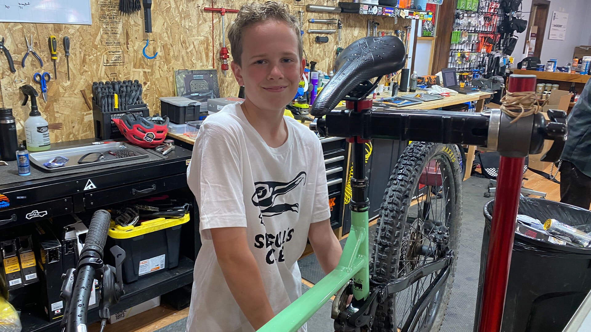 young boy fixing a bike