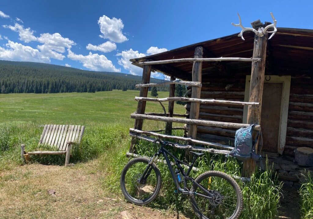 bicycle by cabin in the mountains